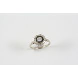 A BLACK ONYX AND DIAMOND CLUSTER RING the central circular-cut diamond is set within a surround of