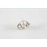A PEARL AND DIAMOND RING the untested pearl is set with three circular-cut diamonds to each