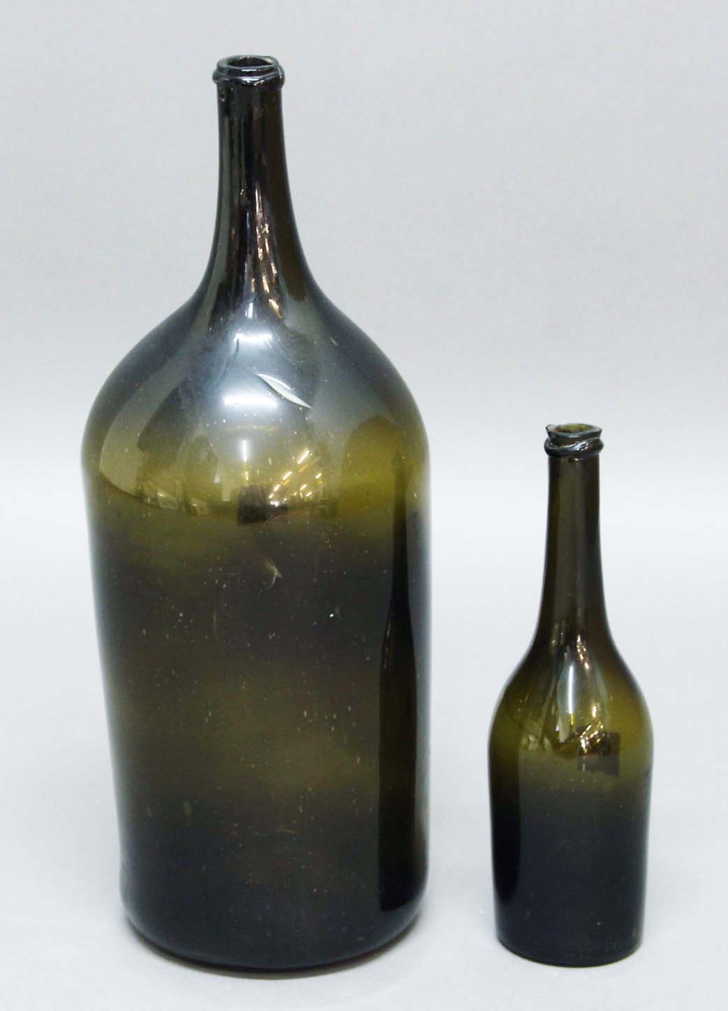 LARGE OLIVE GREEN WINE BOTTLE, probably mid-late 18th century, with broad stringing to the neck