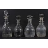 GROUP OF FOUR GLASS DECANTERS AND STOPPERS, 19th century, of mallet forms, with cut and faceted