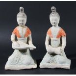 TWO CHINESE POTTERY TOMB FIGURES, probably Han Dynasty, modelled as a girl, kneeling, playing a drum