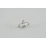 A DIAMOND SOLITAIRE RING the oval-shaped diamond is set in platinum. Size K 1/2. Accompanied by