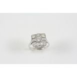 A DIAMOND CLUSTER RING the square-shaped mount is centred with a circular-cut diamond within a