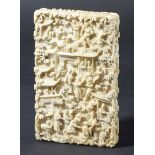 CHINESE CANTON IVORY CARD CASE, carved with figures amongst trees and pavilions, height 10.5cm,