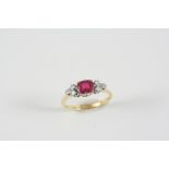 A SYNTHETIC RUBY AND DIAMOND RING the oval-shaped synthetic ruby is set with three circular-cut