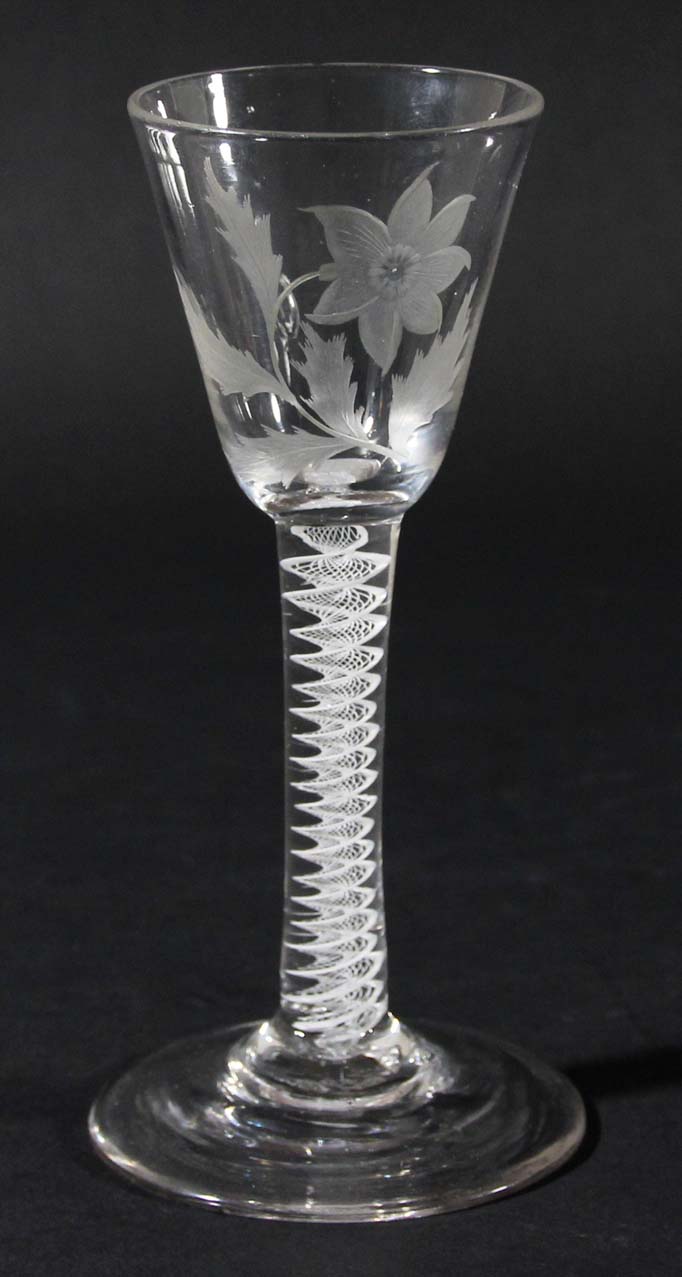 ENGLISH WINE GLASS, circa 1770, the rounded funnel bowl engraved with a flower and foliage on a stem