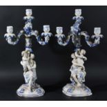 PAIR OF SITZENDORF FOUR LIGHT CANDELABRA, modelled as a classical maiden and cherub holding up the