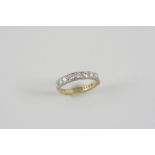 A DIAMOND HALF HOOP RING millegrain set with circular-cut diamonds in 18ct. gold. Size M.