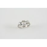 A DIAMOND THREE STONE RING the three graduated old brilliant-cut diamonds are set in 18ct. white