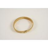 A 9CT. GOLD BRACELET of mesh design, 18.5cm. long, 28 grams.