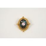 A PIETRA DURA AND GOLD BROOCH of foliate design, set within a a gold ornate mount, 3.5 x 3.0cm.