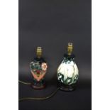 MOORCROFT LAMPS two modern Moorcroft lamps, both with wooden bases and with 1 shade. Largest 29cms
