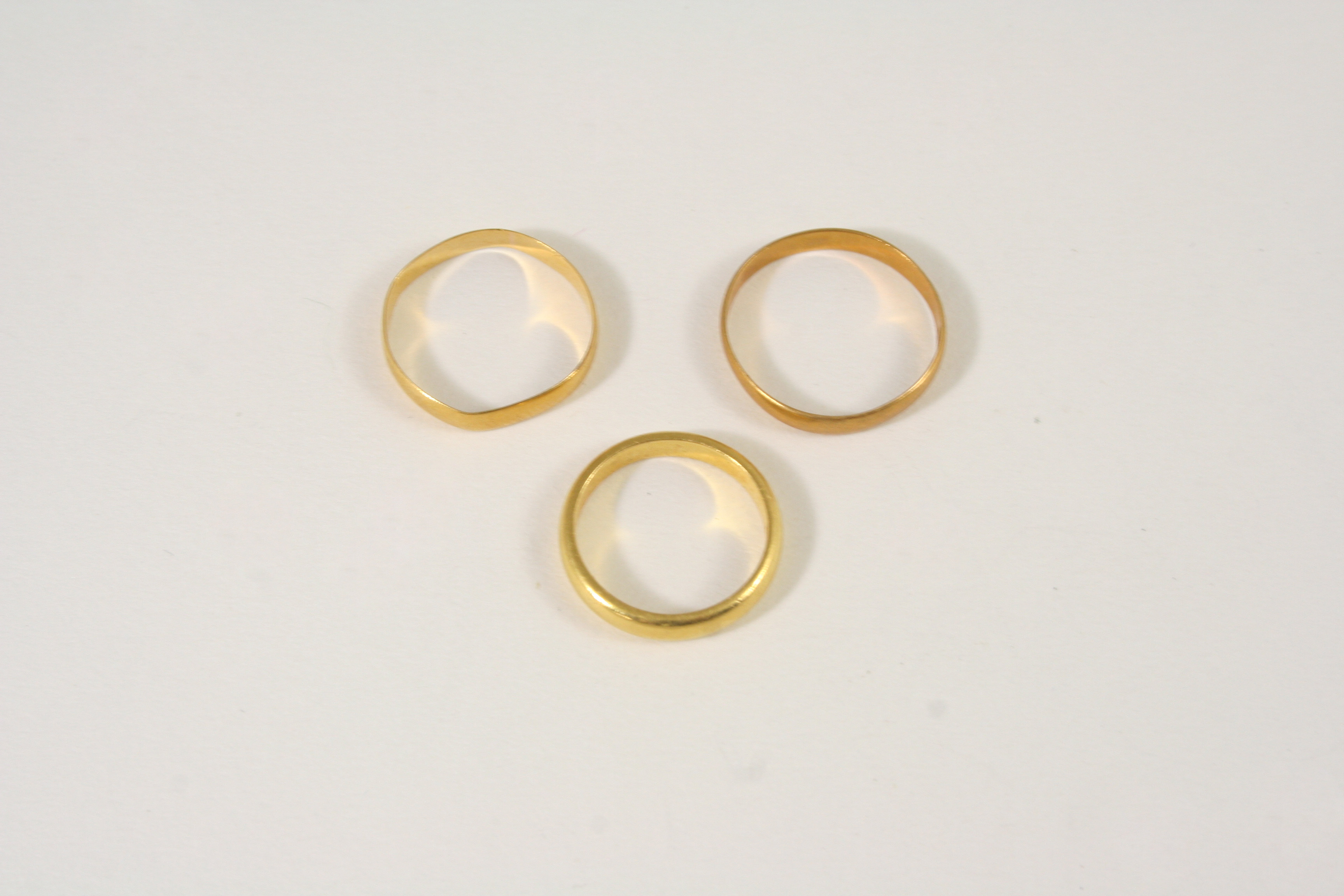 THREE 22CT. GOLD WEDDING BANDS total weight 7.2 grams.