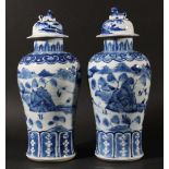 PAIR OF CHINESE BLUE AND WHITE BALUSTER VASES AND COVERS, Kangxi style but later, painted with