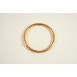 A 15CT. GOLD BANGLE hallmarked for Chester 1948, 17.2 grams.