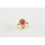 A FIRE OPAL AND DIAMOND CLUSTER RING the oval-shaped fire opal is set within a surround of