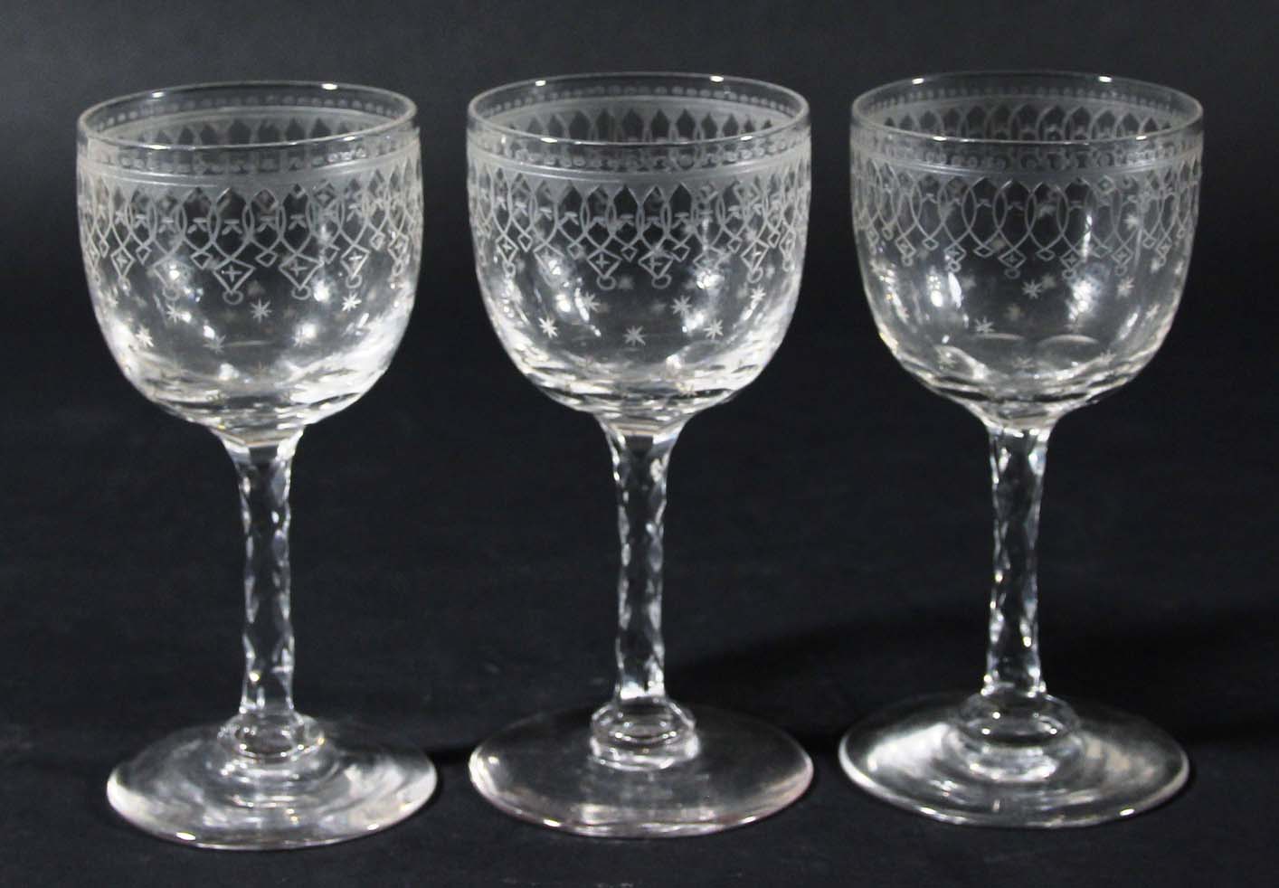 SET OF SIX PORT GLASSES, circa 1900, the rounded bowls engraved with arcading above gilded stars,