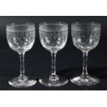 SET OF SIX PORT GLASSES, circa 1900, the rounded bowls engraved with arcading above gilded stars,