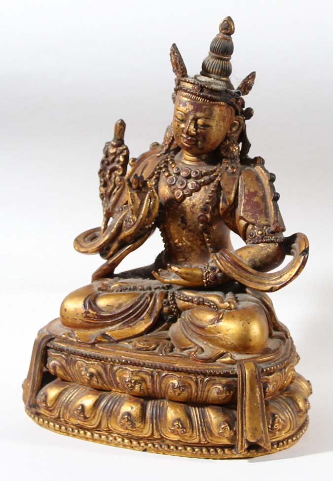 CARVED WOOD, LACQUER AND GILT BODHISATTVA, probably Chinese or Tibetan, seated cross legged on a