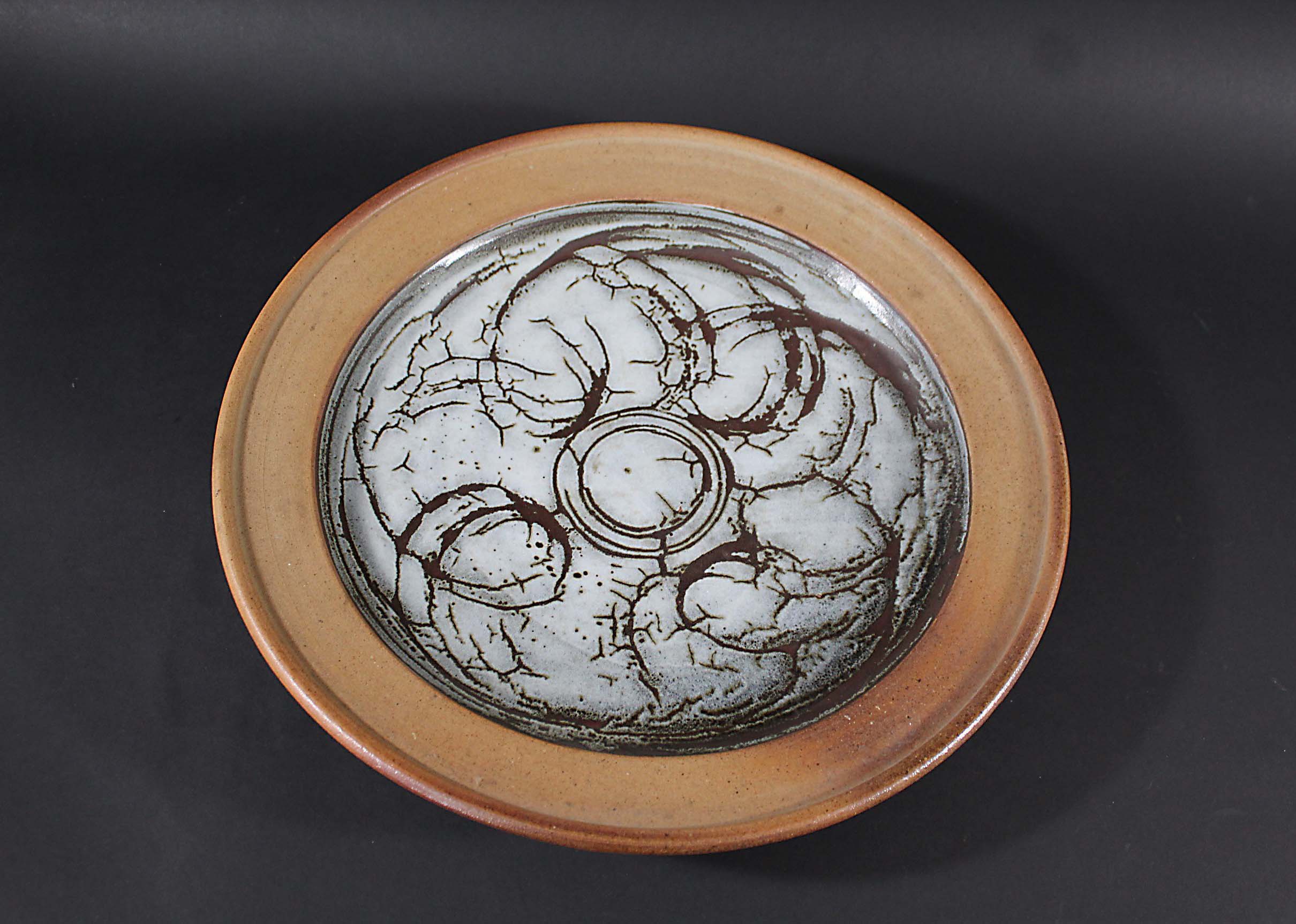 JOHN LEACH - LARGE CIRCULAR DISH a large stoneware dish, the centre glazed. Impressed marks to the