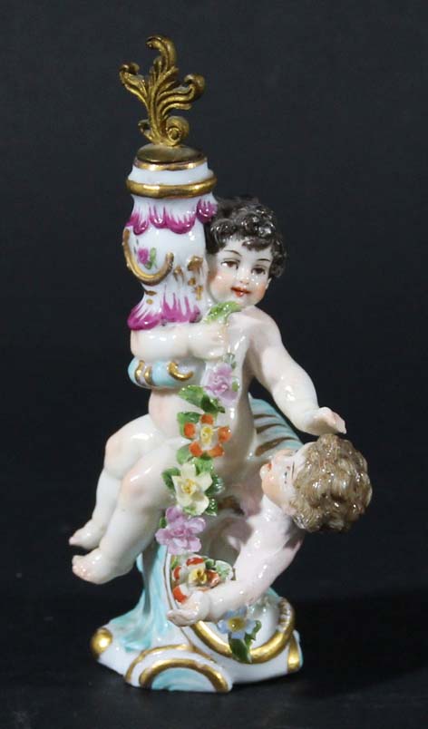 CHELSEA STYLE TOY SCENT BOTTLE, late 19th or 20th century, modelled as two cherubs and a garland