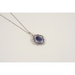 AN EDWARDIAN SAPPHIRE AND DIAMOND PENDANT the oval-shaped sapphire is set within a surround