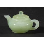 CHINESE CELADON JADE MINIATURE TEAPOT AND COVER, of squat ovoid form, length 9cm (2)