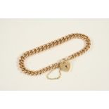 A 9CT. GOLD CURB LINK BRACELET with padlock clasp, 17.5cm. long, 18.4 grams.