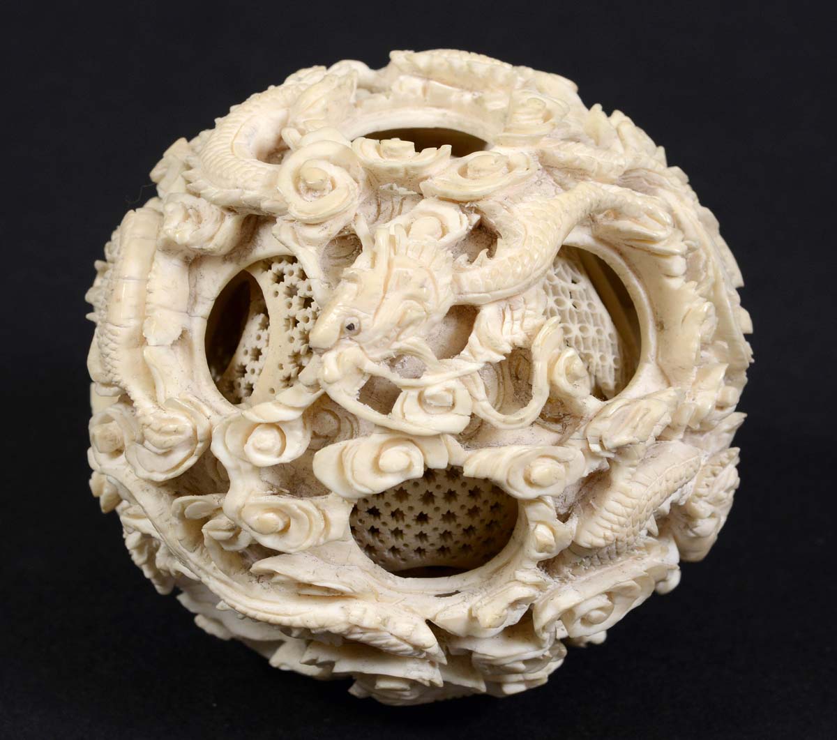 CHINESE CANTON IVORY PUZZLE BALL, 19th century, with 14 concentric balls, the outer ball carved with