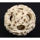 CHINESE CANTON IVORY PUZZLE BALL, 19th century, with 14 concentric balls, the outer ball carved with