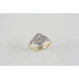 A DIAMOND CLUSTER RING the four central old brilliant-cut diamonds are set within a surround of