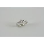 A DIAMOND SOLITAIRE RING the circular-cut diamond weighs 0.25 carats and is set with three graduated