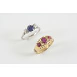 A RUBY AND DIAMOND RING the 18ct. gold mount is set with an oval-shaped ruby, two circular-cut
