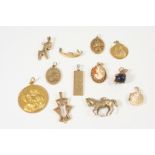 A QUANTITY OF GOLD JEWELLERY including a 9ct. gold pendant, embossed with various emblems, 5.9