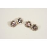 A PAIR OF MOTHER-OF-PEARL AND DIAMOND CUFFLINKS formed as circular sections of mother-of-pearl,