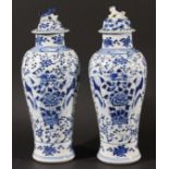 PAIR OF CHINESE BLUE AND WHITE VASES AND COVERS, Kangxi style, of inverted baluster form painted