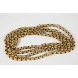 A VICTORIAN GOLD LONG GUARD CHAIN formed with granulated embossed circular links, 92cm. long, 22.8