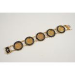 A GOLD HALF SOVEREIGN BRACELET formed with five half sovereigns, 1910, 1911, 1912,1914, 1904