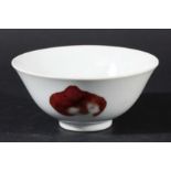 CHINESE FOOTED BOWL, copper red decorated with a pomegranate and two peaches, Yongzheng style four