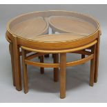NATHAN 'TRINITY' NEST OF TABLES a mid 20thc teak circular table with a glass top, and with 3 smaller