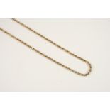 A 9CT. TWO COLOUR GOLD NECKLACE of rope link design, 45.5cm. long, 14 grams.