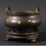 CHINESE BRONZE AND GOLD SPLASH CENSER AND STAND, Xuande mark but later, of circular, two handled,