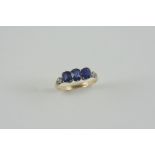 A SAPPHIRE AND DIAMOND RING the three oval-shaped sapphires are set with two rose-cut diamonds to