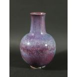 RUSKIN HIGH FIRED VASE - 1909 a bottle shaped high fired vase, with a purple speckled glaze.