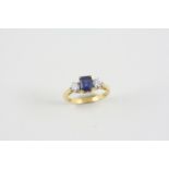 A SAPPHIRE AND DIAMOND THREE STONE RING the rectangular-shaped sapphire is set with two circular-cut