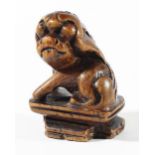 CHINESE BOXWOOD GUARDIAN LION, possibly late Ming, seated on a rectangular plinth, height 4.5cm