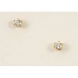 A PAIR OF DIAMOND STUD EARRINGS each set with a circular-cut diamond, in gold.