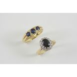 A SAPPHIRE AND DIAMOND CLUSTER RING the oval-shaped sapphire is set within a surround of single-