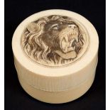 TWO JAPANESE IVORY CIRCULAR BOX AND COVERS, Meiji, one carved with a roaring lions head the other