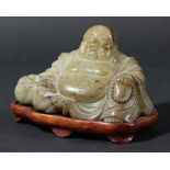 CHINESE SPECKLED CELADON JADE BUDDHA, modelled seated, on a hardwood base, excluding base height 6.